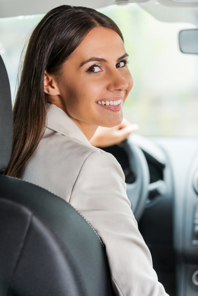 Businesswoman driving car.